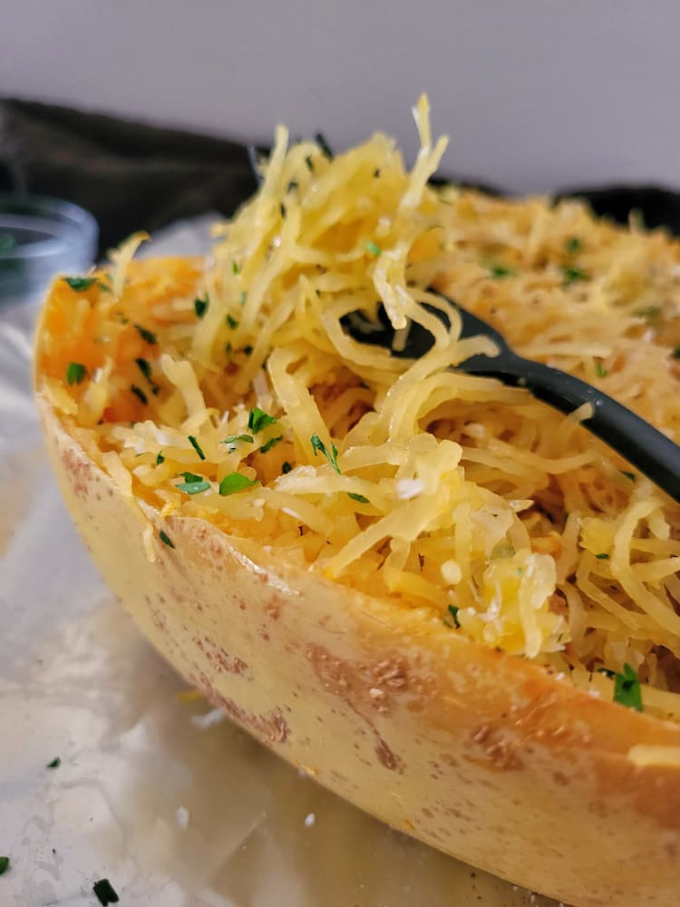 side view of cooked spaghetti squash garnished with parsley