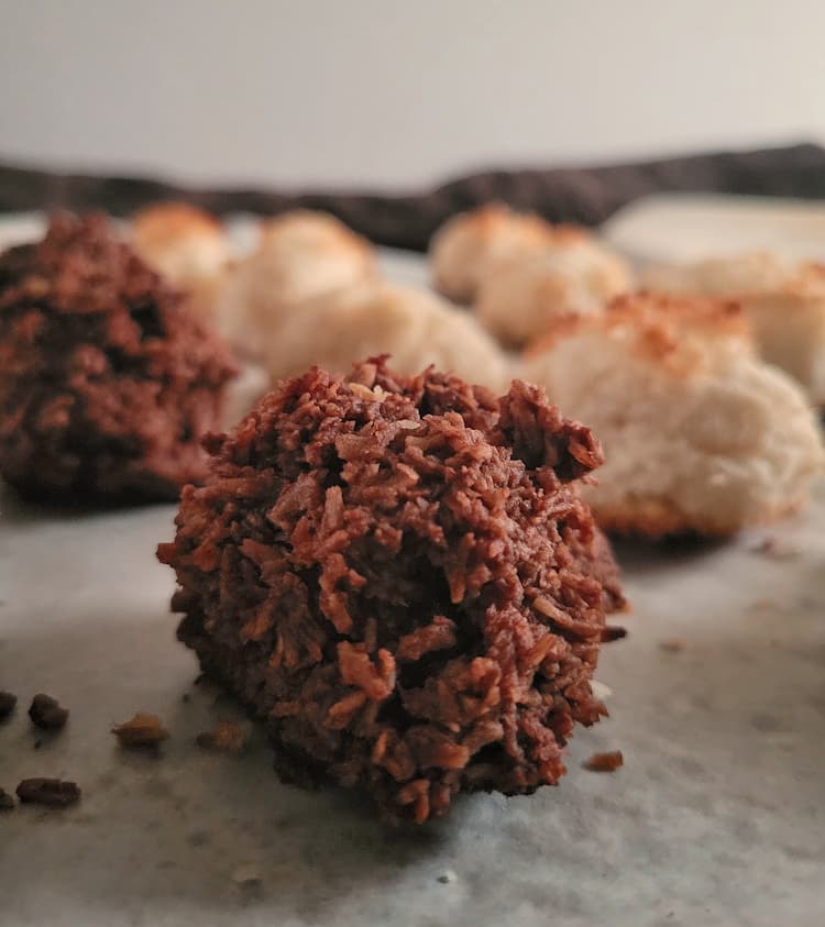close up of a chocolate macaroon, more plus coconut ones in the background