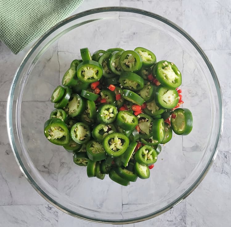 bowl of sliced jalapeños and thai red chilies