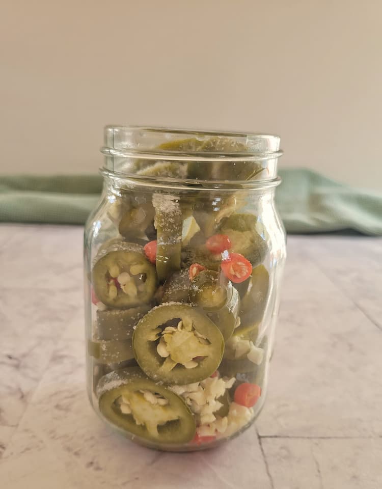 jar of sliced jalapeños, thai red chilies, minced garlic and a pinch of salt