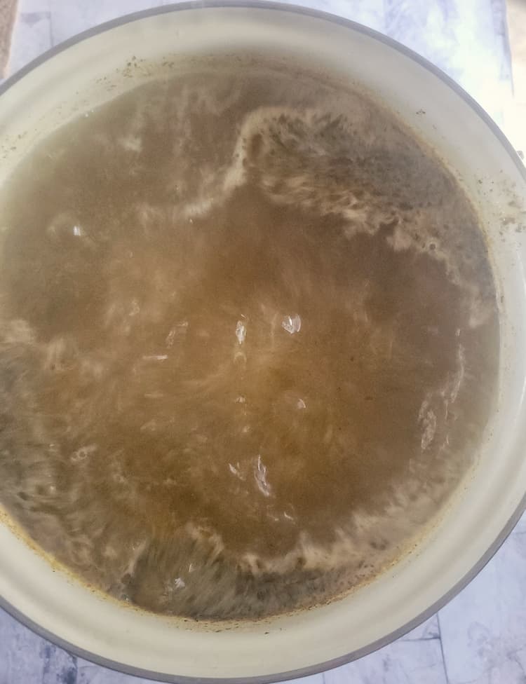 dark liquid at a rolling boil in a pot