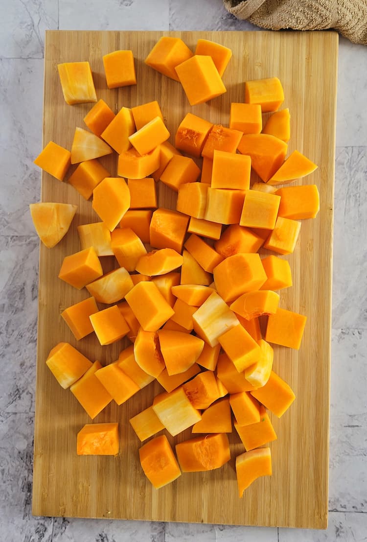 cubed pieces of butternut squash on a cutting board