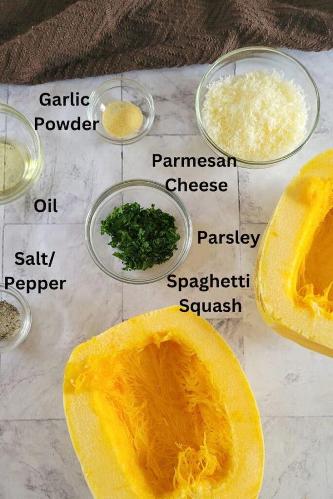ingredients for air fryer spaghetti squash - spaghetti squash, parmesan cheese, parsley, garlic powder, oil, salt/pepper