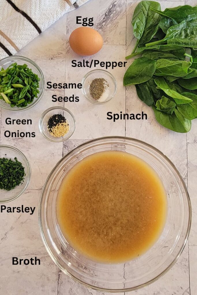 ingredients for keto egg drop soup - broth, egg, salt/pepper, spinach, sesame seeds, green onions, parsley