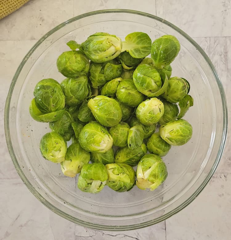 bowl of brussels sprouts seasoned with salt and pepper