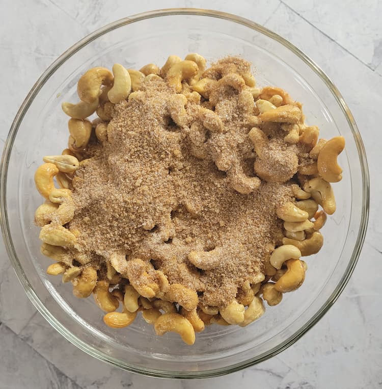 bowl of cashews with brown sugar and spices on top