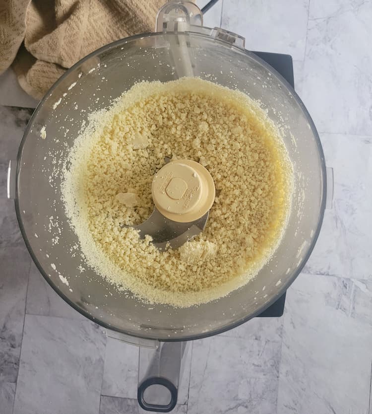 base of a food processor with finely chopped white chocolate