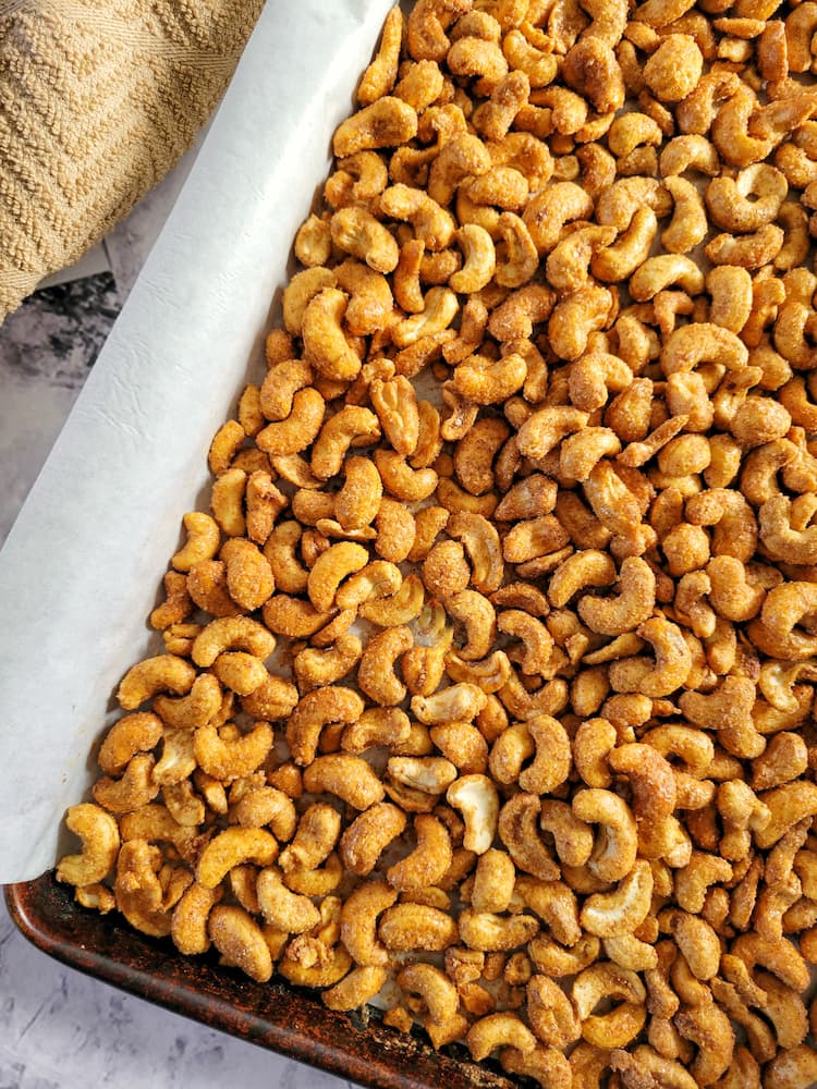 parchment lined baking sheet with candied cashews