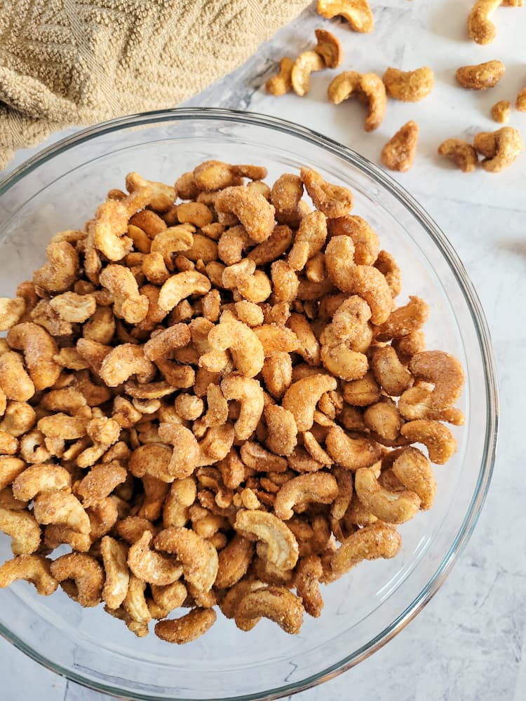 bowl of candied cashews with some in the background