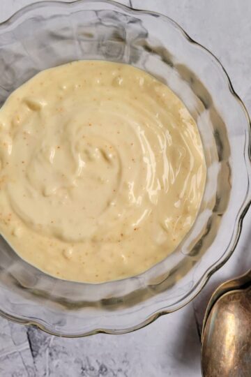 bowl of aioli with two spoons on the side