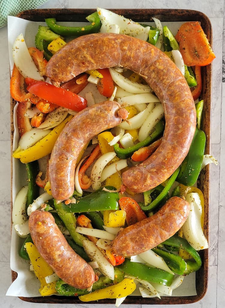 sheet pan with sausage, sliced bell peppers and onions