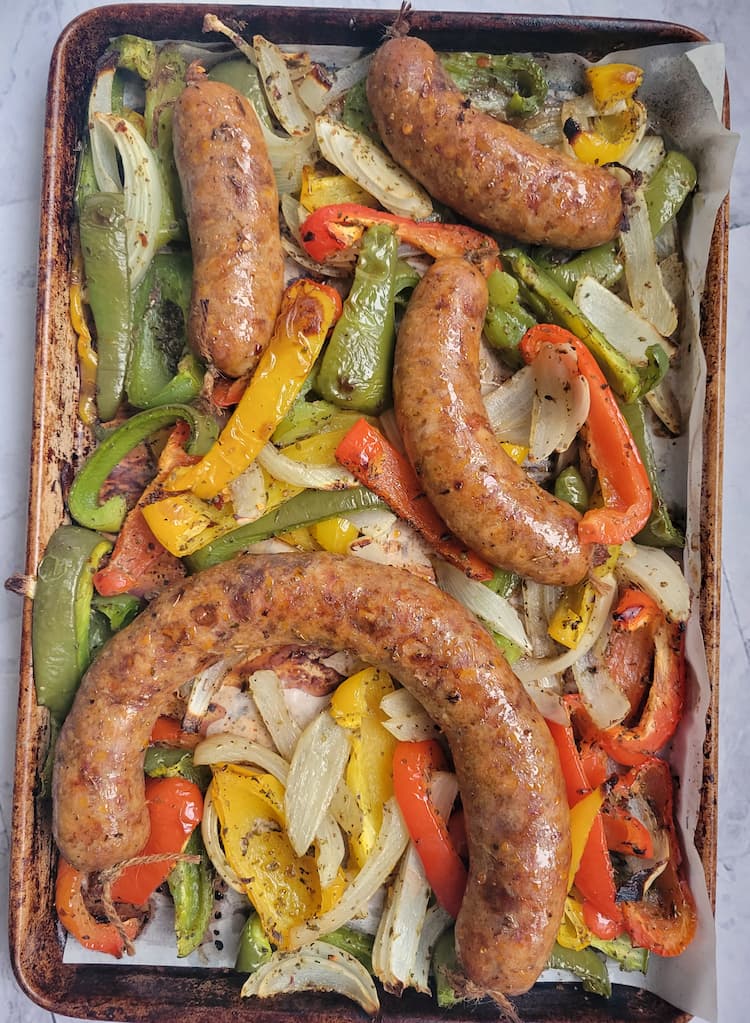 sheet pan with cooked sausage, bell peppers and onions