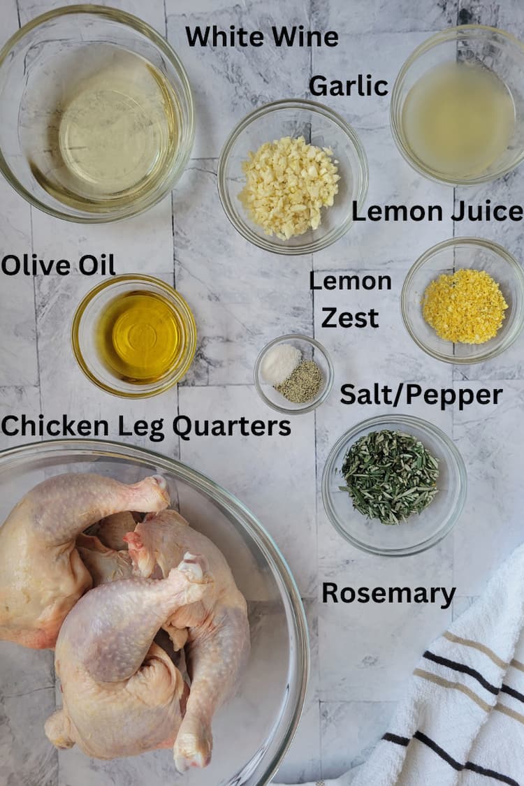 ingredients for recipe for chicken with rosemary - chicken leg quarters, rosemary, garlic, olive oil, white wine, lemon juice and zest, salt and pepper