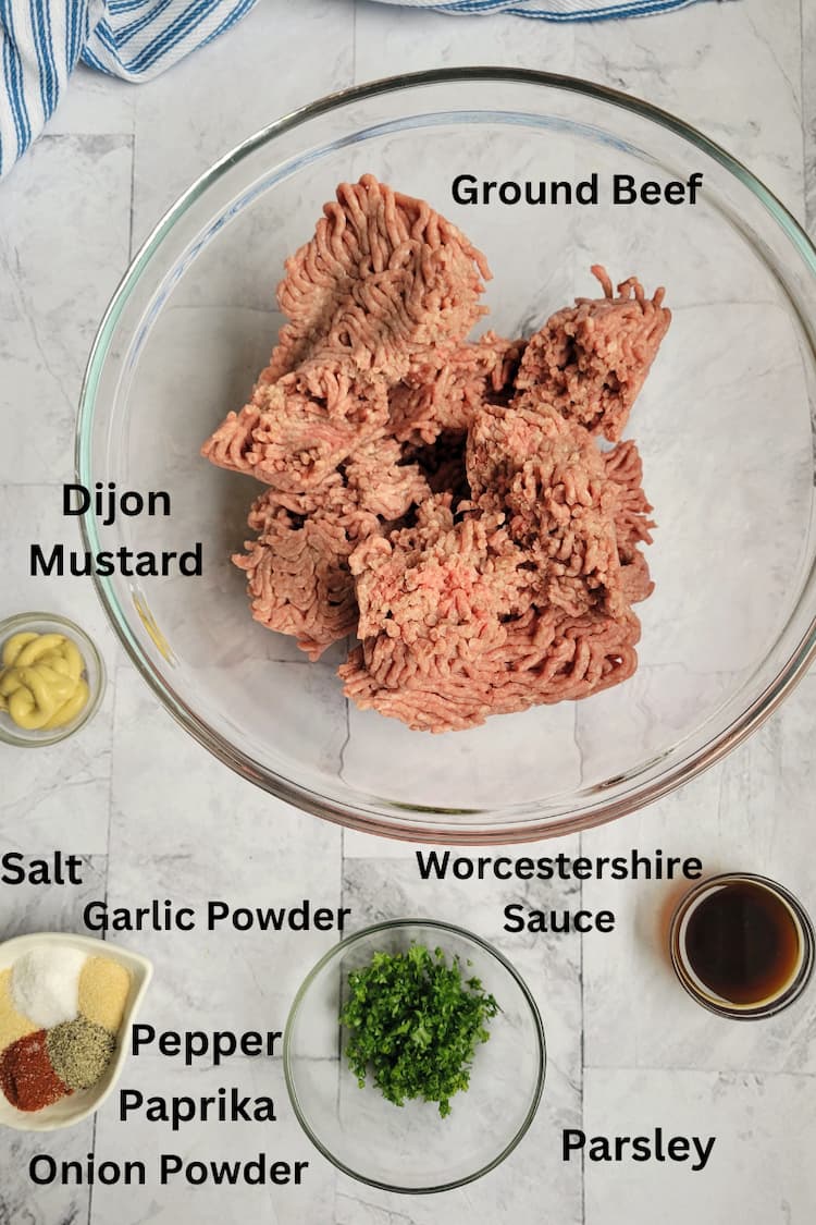 ingredients for recipe for ground beef burgers - ground beef, dijon mustard, parsley, worcestershire sauce, salt, garlic powder, pepper, onion powder, paprika