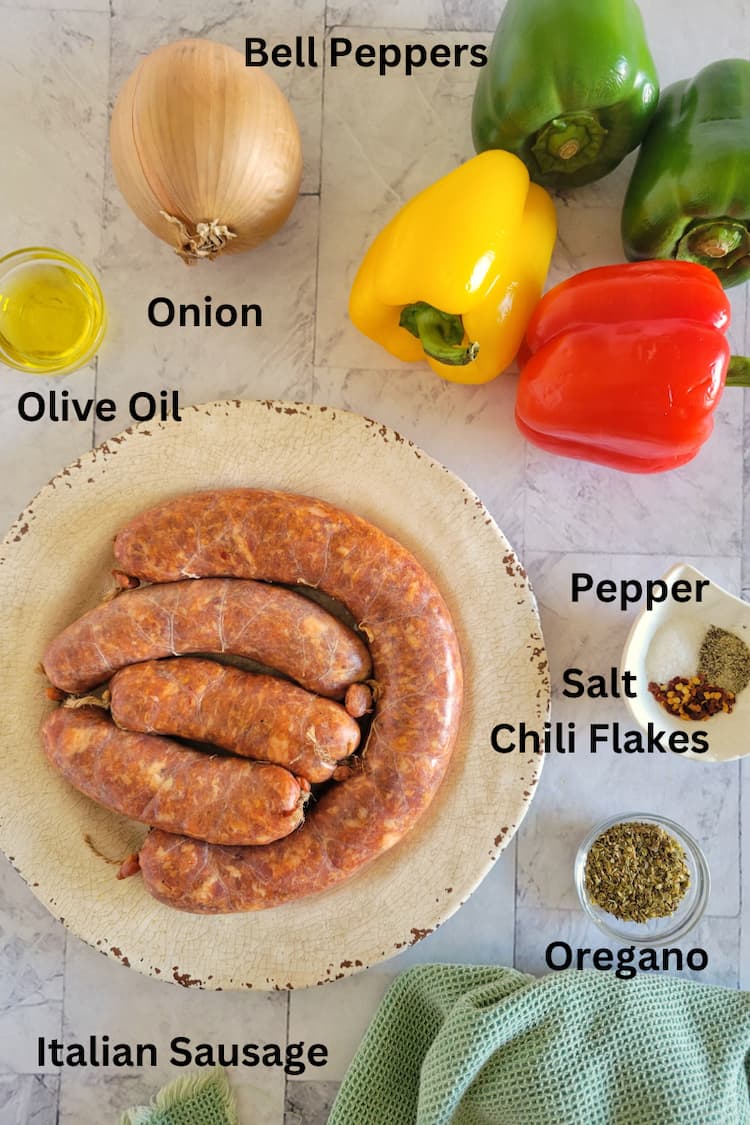 ingredients for sausage with pepper and onions - italian sausage, bell peppers, onion, olive oil, salt, pepper, oregano and chili flakes