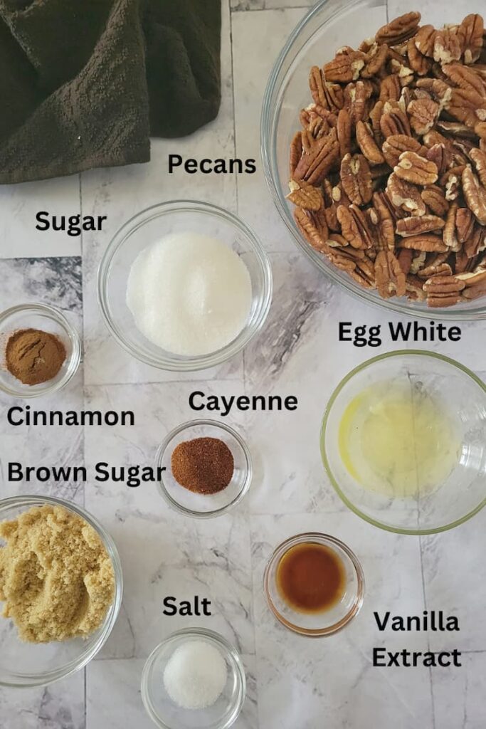 ingredient list for spiced candied pecans - pecans, cinnamon, brown and white sugar, vanilla extract, egg white, cayenne, salt