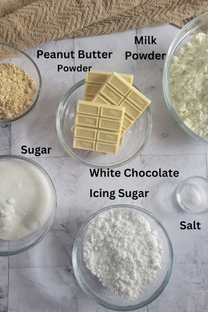 ingredients for recipe for white hot chocolate - milk powder, white chocolate, salt, icing sugar, sugar, peanut butter powder