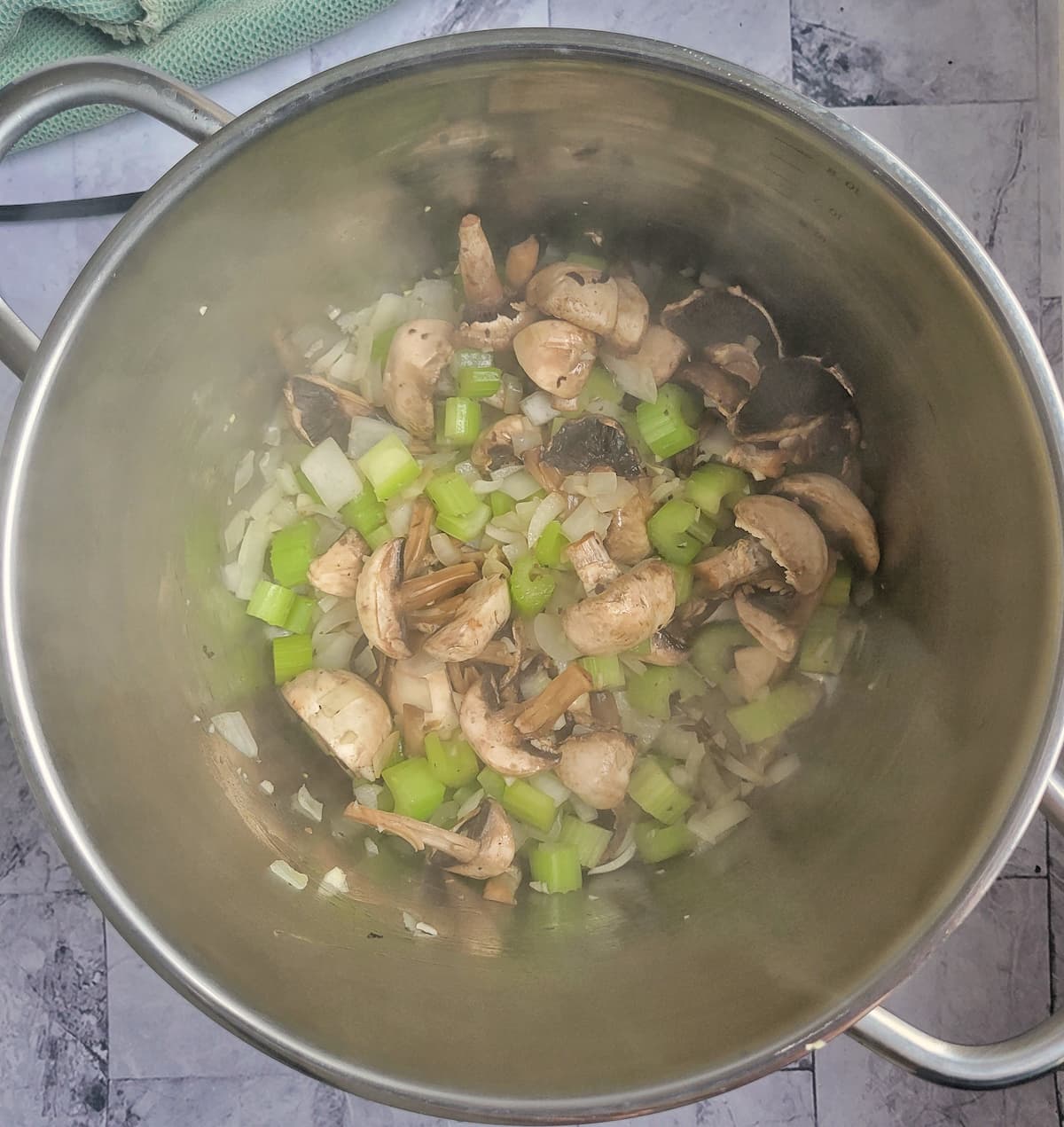 pot with sliced mushrooms, diced onion and celery