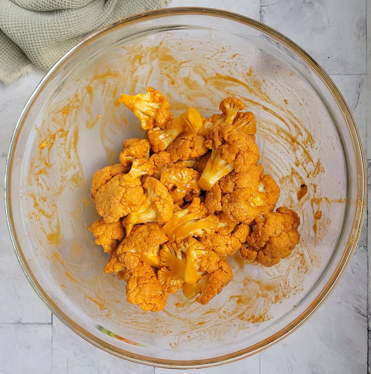 cauliflower florets with buffalo sauce in a bowl