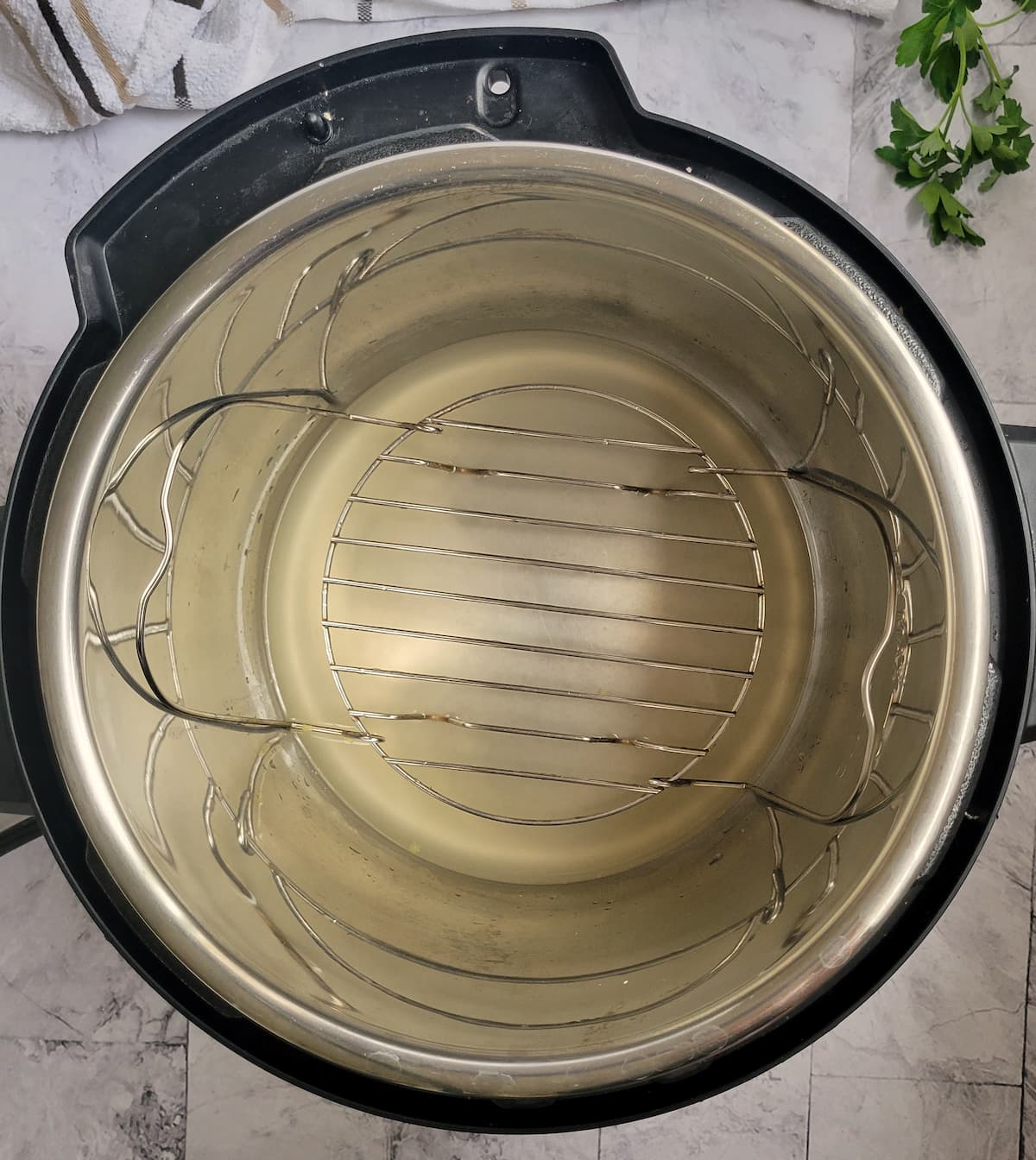 metal trivet in the instant pot with chicken broth