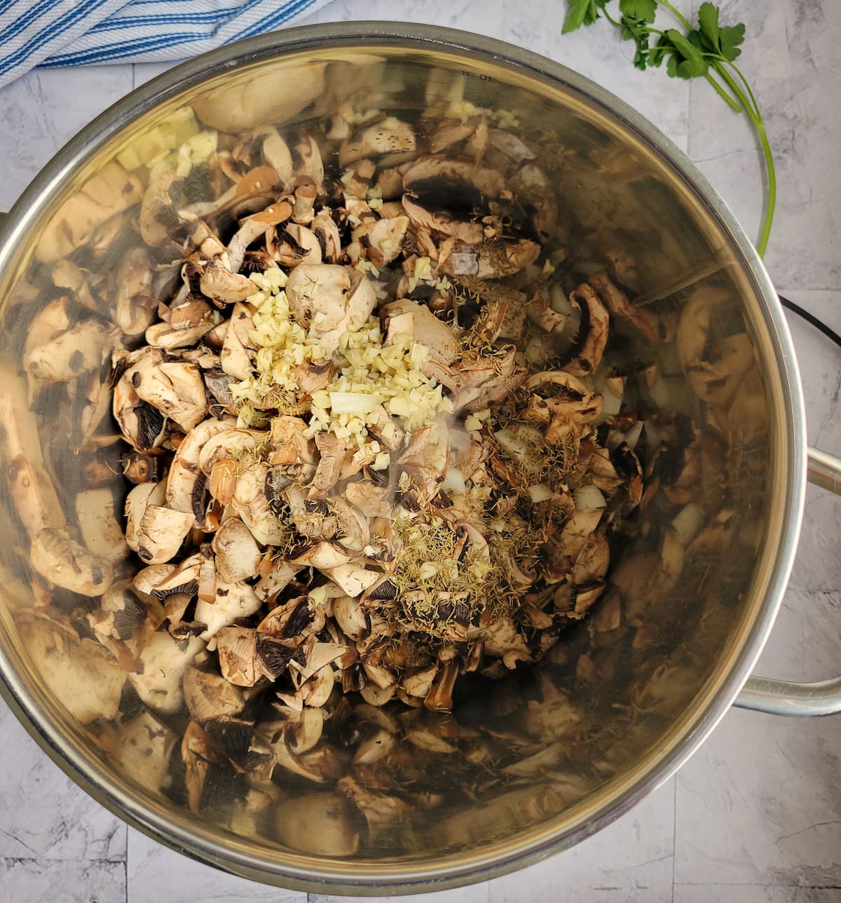 pot with sliced mushrooms, minced garlic and spices