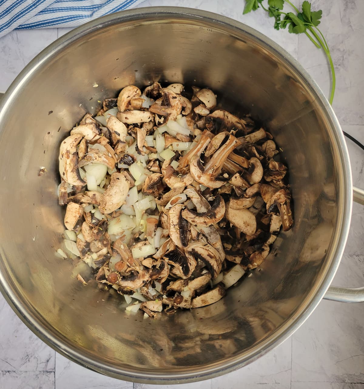pot of sliced mushrooms and diced white onions