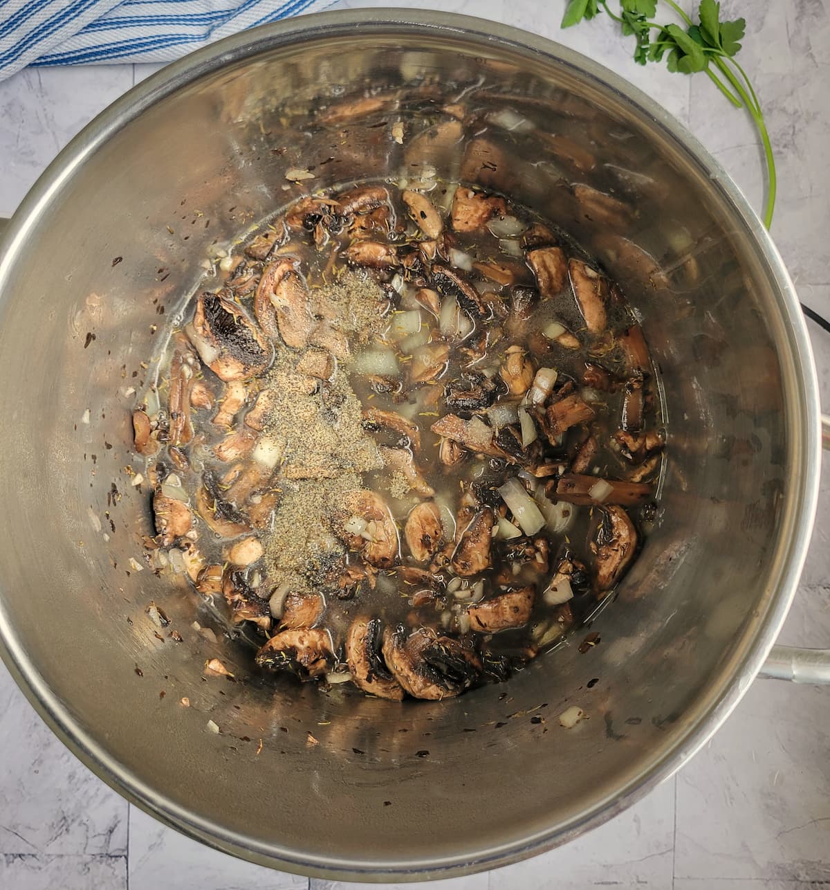 sliced mushrooms, spices and broth in a large pot