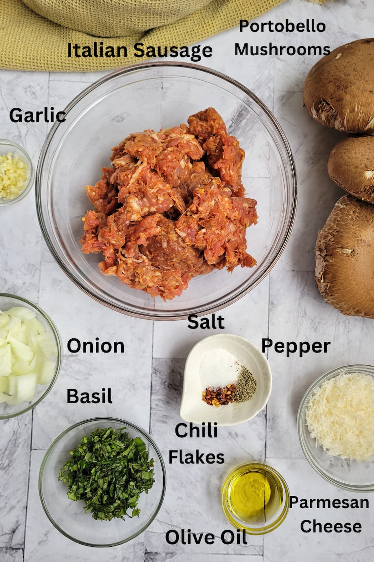 ingredients for sausage stuffed portobello mushrooms - portobellos, italian sausage, garlic, onion, basil, parmesan cheese, pepper, salt, chili flakes