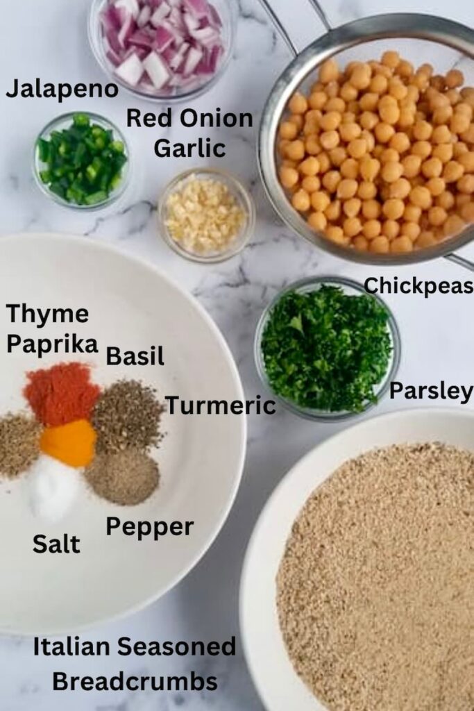the ingredients to make chickpea patties: rinsed and drained canned chickpeas in a fine mesh strainer, minced garlic in a clear small bowl, chopped fresh parsley in a clear small bowl, diced jalapenos and red onions in clear small bowls, an array of spices in a white bowl and seasoned italian breadcrumbs in a white bowl