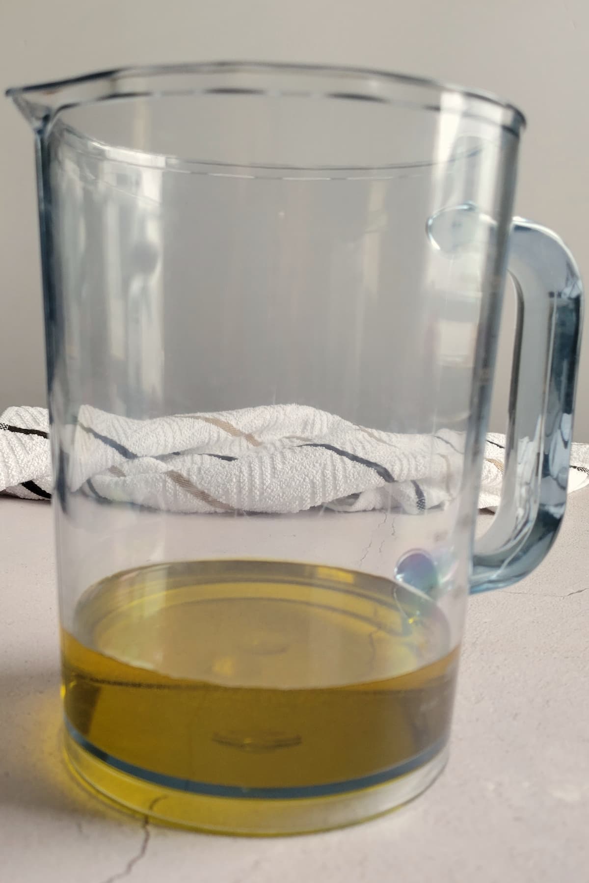 a cup of oil in a jug