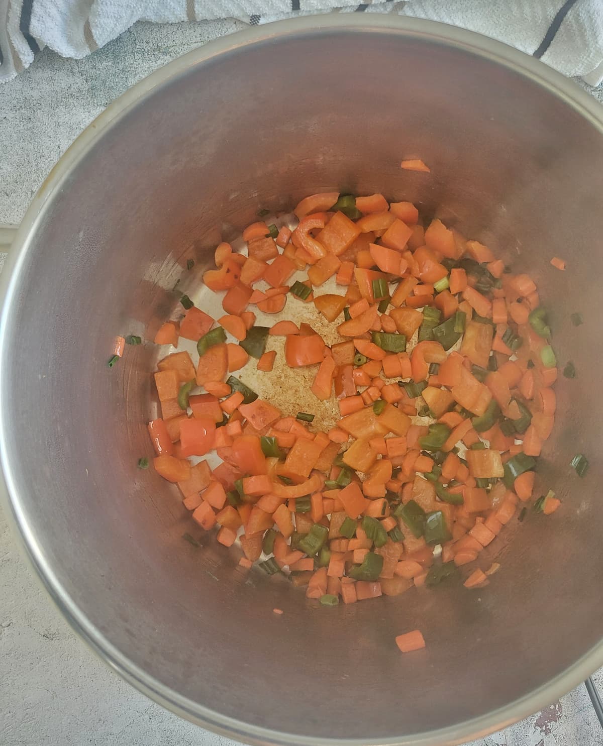 diced carrots, green onion and jalapeño sautéeing in a large pot