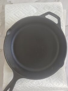 black cast iron skillet on paper towel