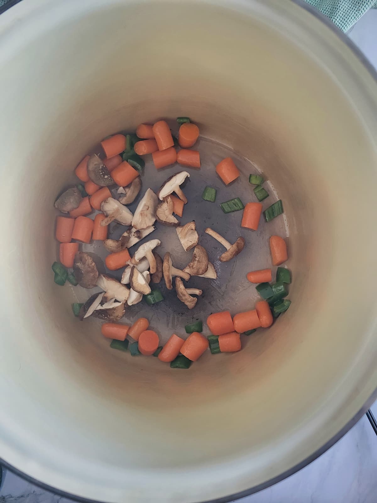 pot with baby carrots, jalapenos and mushrooms
