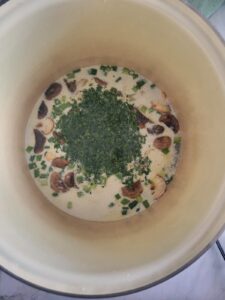 chopped parsley, green onions and sliced mushrooms in a creamy broth