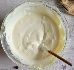 bowl of whipped cream and a small rubber spatula