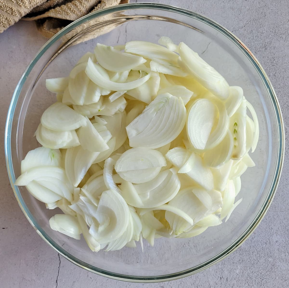 sliced white onions in a bowl