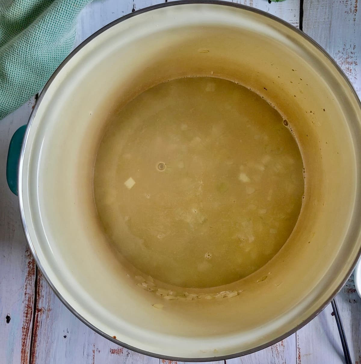 chicken broth in a pot with other ingredients