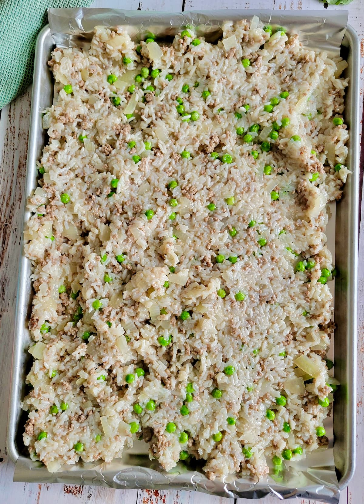 sheet pan of cooked rice, peas and ground beef