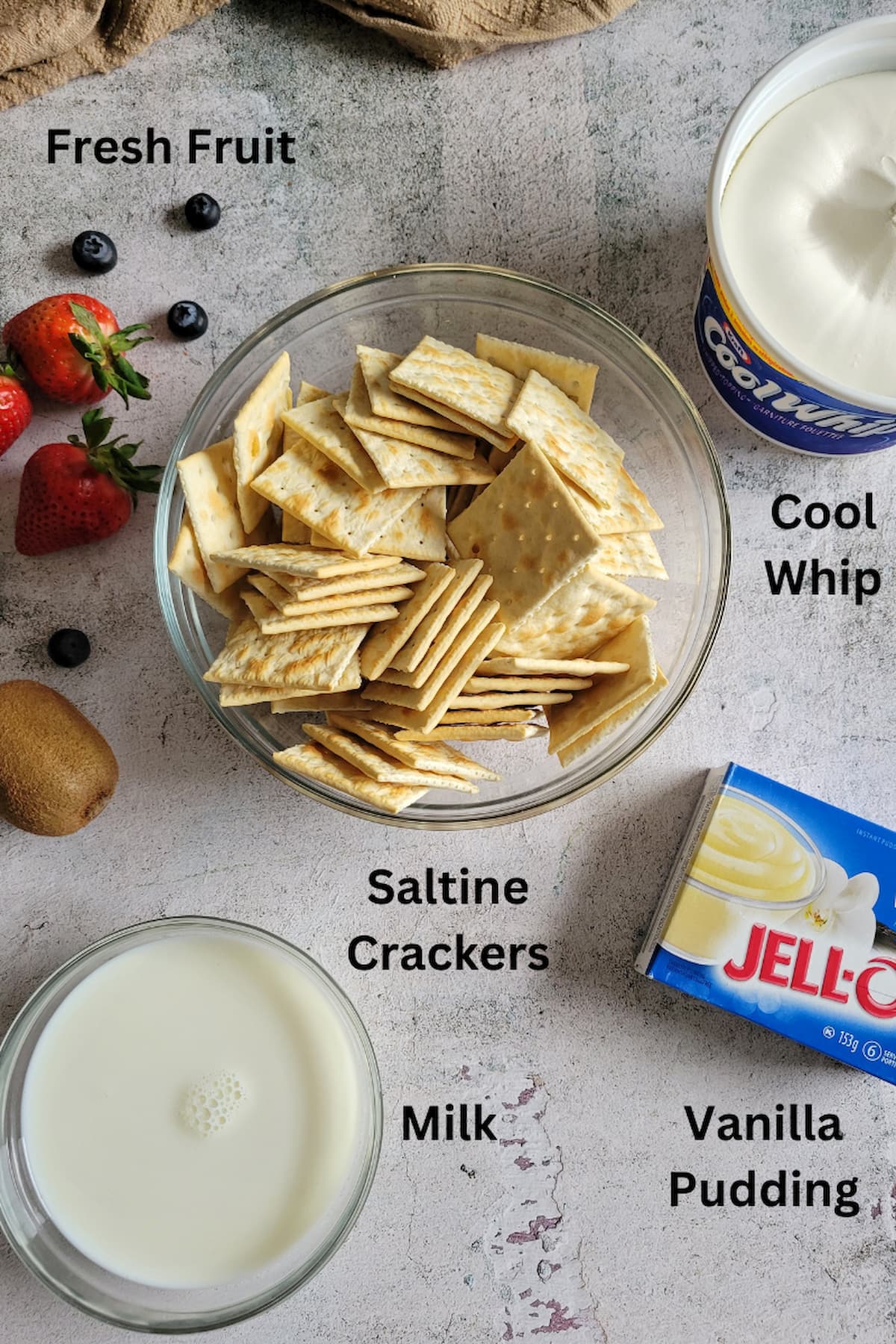 ingredients for sfoglia cake - saltine crackers, cool whip, vanilla pudding, milk, fresh fruit