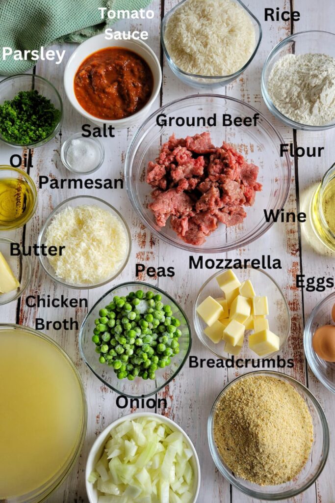 ingredients for arancini - rice, flour, eggs, wine, butter, parsley, mozzarella, parmesan, salt, chicken broth, breadcrumbs, peas, oil, tomato sauce, ground beef