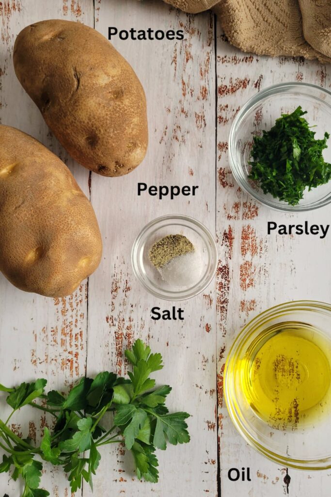 ingredients for potato wedges - potatoes, pepper, salt, parsley, oil