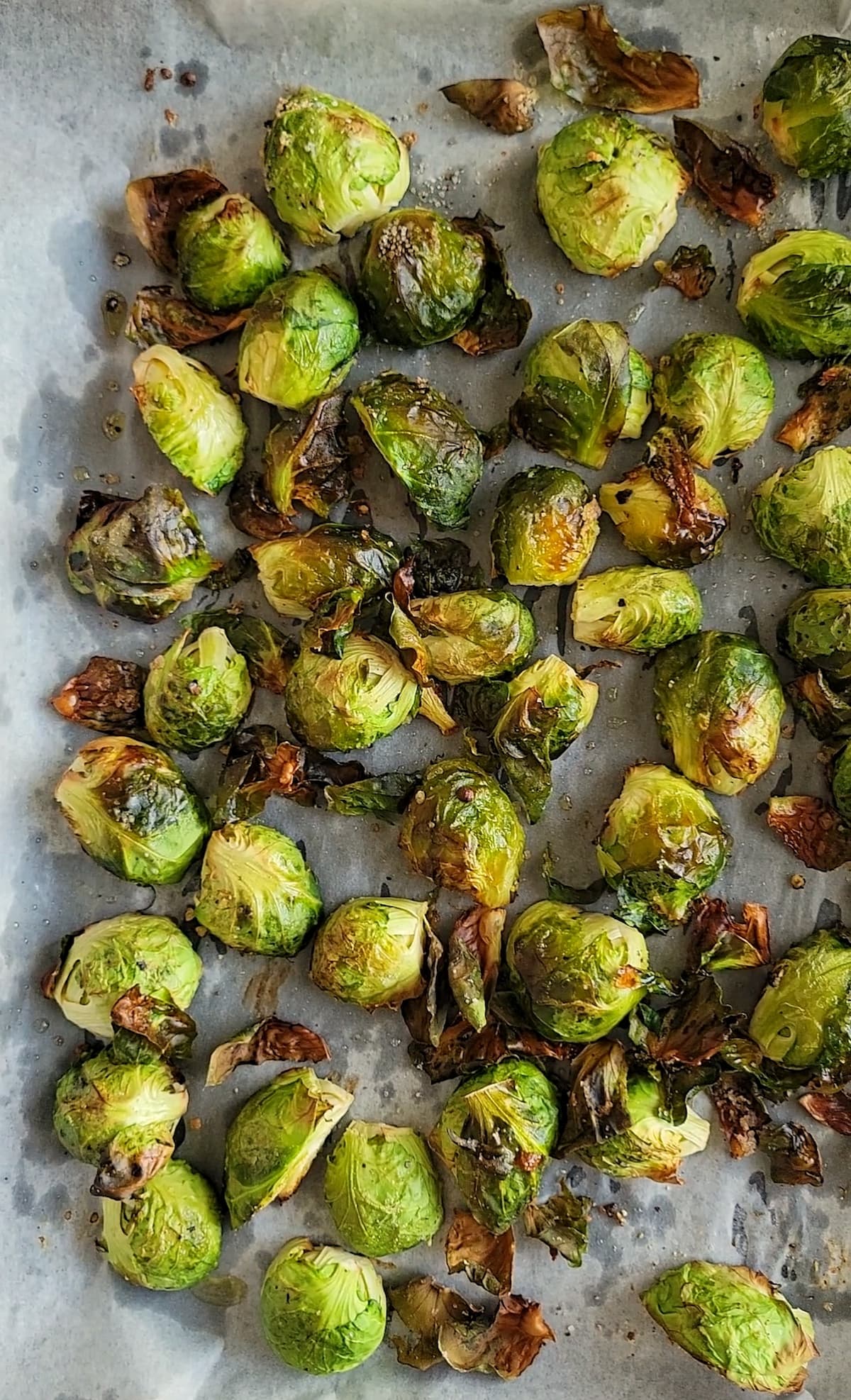 parchment lined sheet pan with crispy roasted brussels sprouts