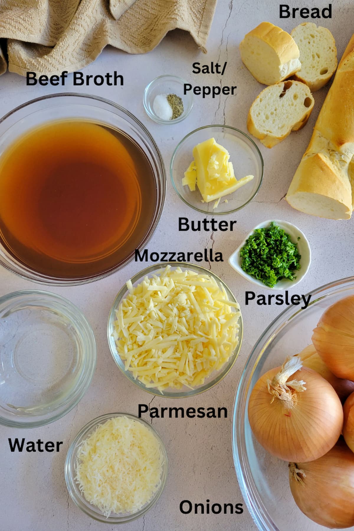 ingredients for french onion soup - onions, bread, beef broth, water, salt/pepper, mozzarella, parmesan, butter, parsley