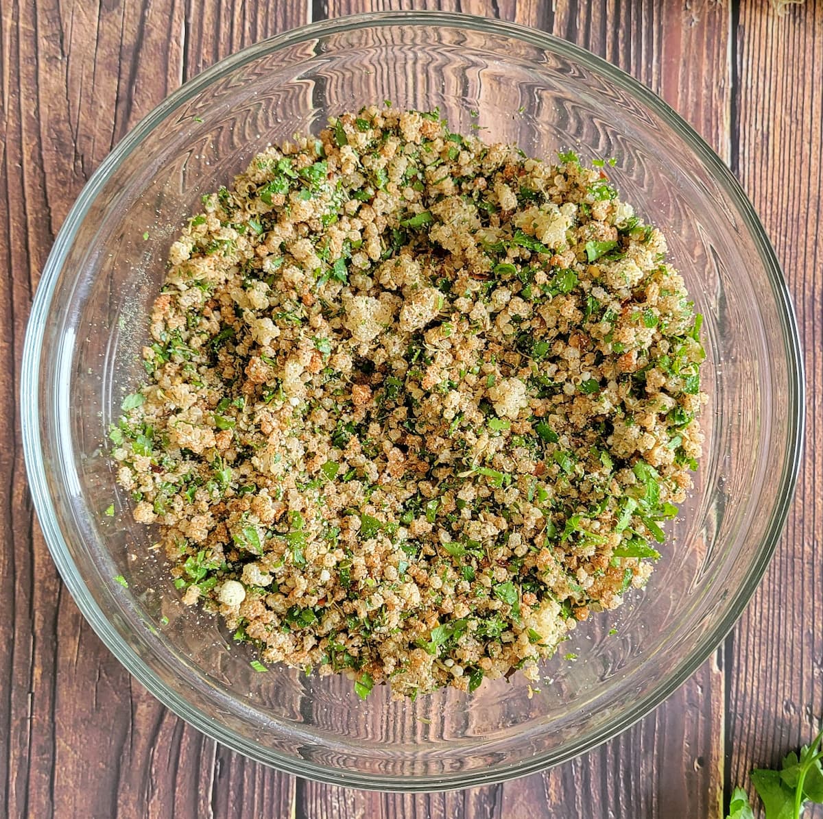 quinoa, fresh parsley, parmesan and spices mixed in a bowl
