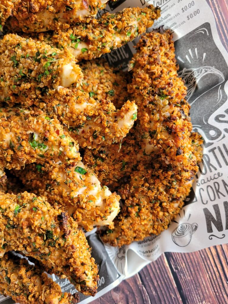 quinoa coated chicken tenders in a lined basket