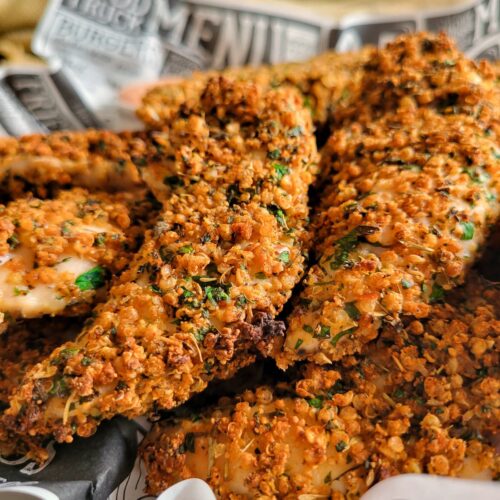 quinoa coated chicken tenders in a lined basket