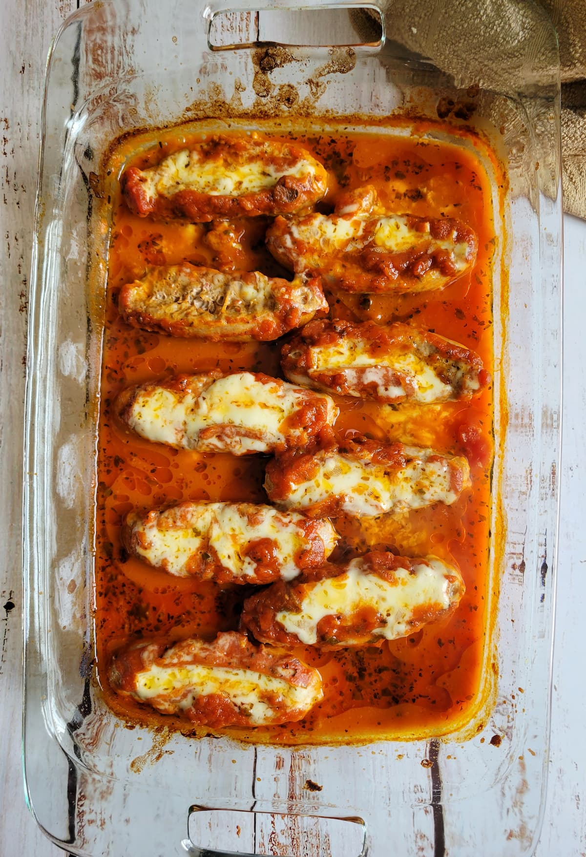 melted cheese stuffed sausages in tomato sauce
