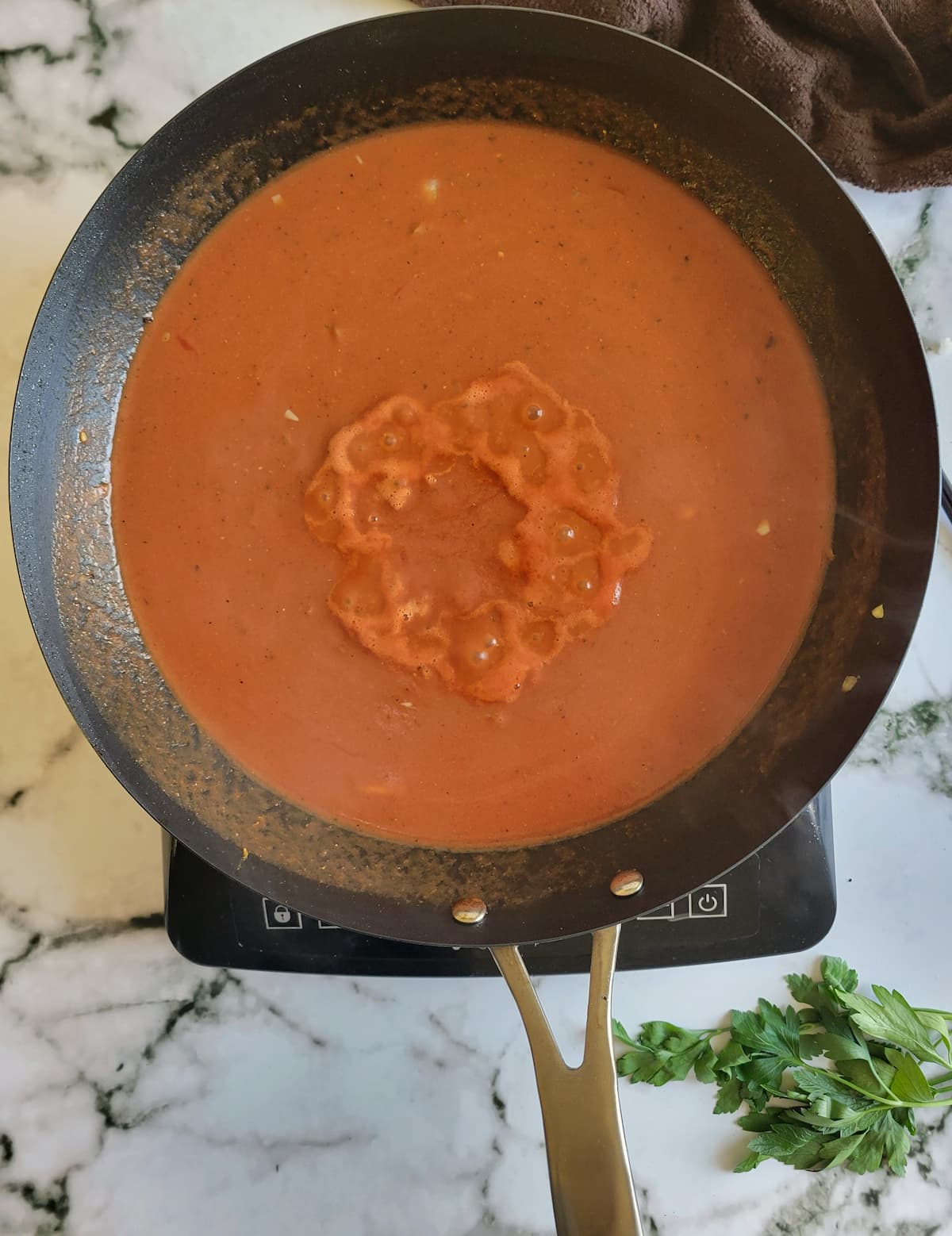 red sauce in a pan on a burner