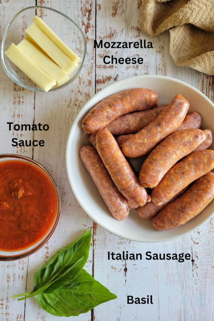 ingredients for stuffed sausages recipe - italian sausage, tomato sauce, mozzarella cheese, basil
