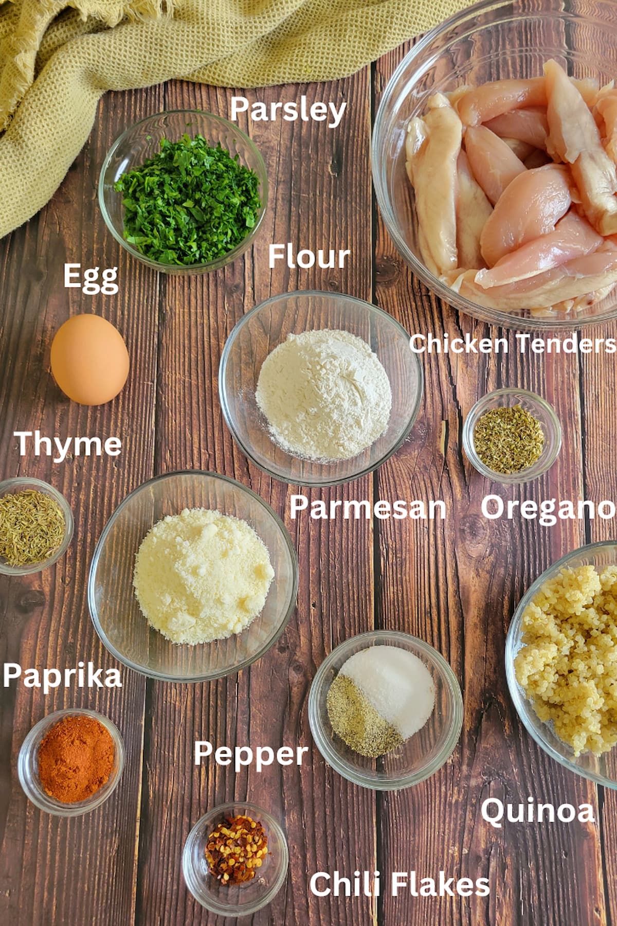 ingredients for quinoa chicken tenders - chicken tenders, parsley, flor, eggs, thyme, oregano, parmesan, chili flakes, quinoa, paprika, pepper, salt
